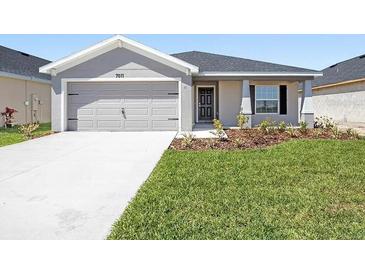 Charming single-story home featuring a well-maintained lawn, neutral paint, and a two-car garage at 7011 161St E Ter, Parrish, FL 34219