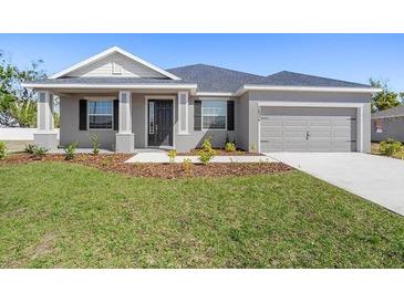 Charming single-story home featuring a well-manicured lawn and attached two-car garage at 2634 58Th E Cir, Palmetto, FL 34221