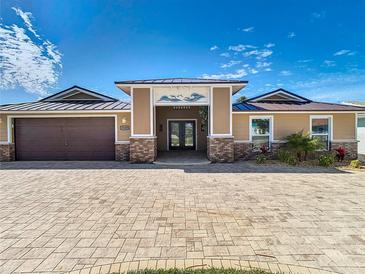 Charming single-story home featuring a paved driveway and a welcoming entryway with decorative accents at 5509 Pilots Pl, New Port Richey, FL 34652