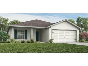 Charming single-story home featuring a two-car garage, shutters, and landscaped front yard at 6030 Mangrove Creek Rd, Wimauma, FL 33598