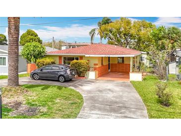 Charming home featuring a car port, well-maintained lawn, and mature trees at 4745 Floramar Ter, New Port Richey, FL 34652