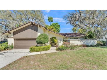Charming single-Gathering home featuring a well-manicured lawn and attached two-car garage at 1316 Cambron Dr, Valrico, FL 33596