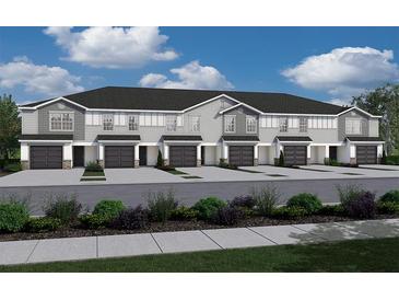 New townhome exterior featuring a gray color scheme, black roof, and one car garage at 2767 Walden Town Cir, Plant City, FL 33566