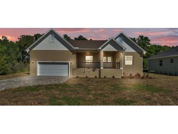 Charming single-Gathering home with a two-car garage and manicured lawn at 12500 Green Oak Ln, Dade City, FL 33525