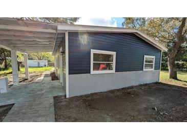 Charming home featuring durable siding, a covered carport, and a freshly painted exterior at 37906 Tucker Rd, Zephyrhills, FL 33542
