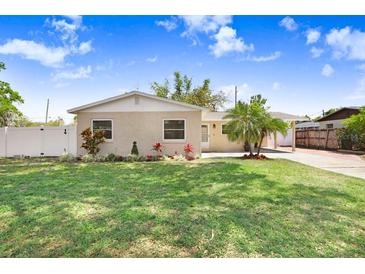 Charming single-story home featuring a well-manicured lawn and a welcoming brick facade at 1411 Fernwood Pl, Seffner, FL 33584