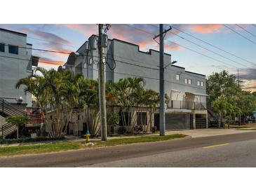Modern gray multi-story home with palm trees and concrete accents, and a street view at dusk at 5008 S Macdill Ave # 12, Tampa, FL 33611