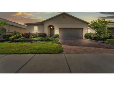 Charming single-story home with a brick driveway and beautifully landscaped front yard at 3134 Macintosh Rd, Land O Lakes, FL 34639