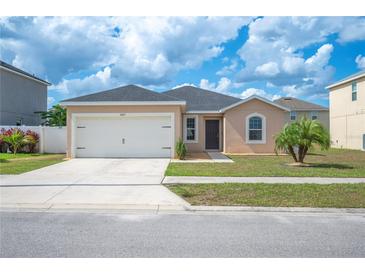 Charming single-story home features a two-car garage, landscaped yard, and neutral exterior paint at 3425 San Moise Pl, Plant City, FL 33567