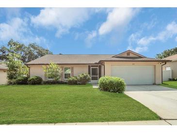 Charming single-story home with a well-manicured lawn and attached two-car garage at 625 Chilt Dr, Brandon, FL 33510