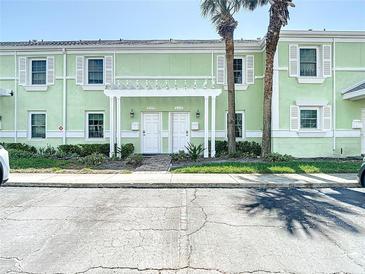 Charming two-story condo with white shutters and a welcoming pergola over the front doors at 4778 Coquina Key Se Dr # 4778, St Petersburg, FL 33705