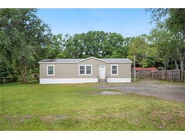 Charming single-story home featuring a well-maintained lawn and inviting front entrance at 6433 Mangrove Dr, Wesley Chapel, FL 33544