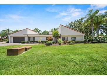 Charming single-story home with well-maintained landscaping and a lush green lawn at 107 Seville N Ct, Plant City, FL 33566