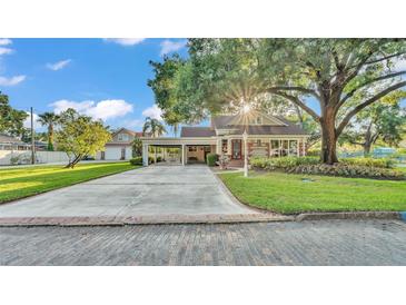 Charming home boasts lush landscaping, covered parking, and a welcoming fountain, blending comfort and curb appeal at 607 N Merrin St, Plant City, FL 33563