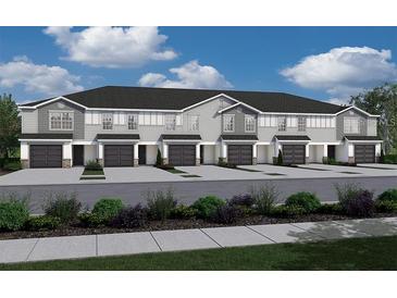 New townhome construction shows attached garages, gray siding, and landscaped grounds at 2764 Walden Town Cir, Plant City, FL 33566
