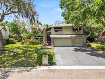 Charming two-story home with a spacious three-car garage and a well-maintained lawn at 2872 Hammock Dr, Plant City, FL 33566