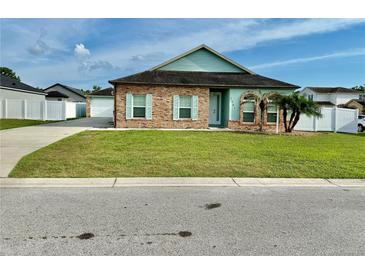 Charming single-story home with brick accents, lovely landscaping, and a well-maintained front yard at 1201 Lavender Jewel Ct, Plant City, FL 33563