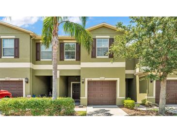 Charming townhome with a well-maintained exterior, lush landscaping, and a private garage at 2622 Lantern Hill Ave, Brandon, FL 33511