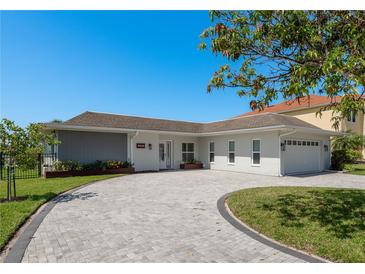 Charming single-story home featuring a brick driveway, attached garage, and manicured landscaping at 3626 Corsair Ct, New Port Richey, FL 34652