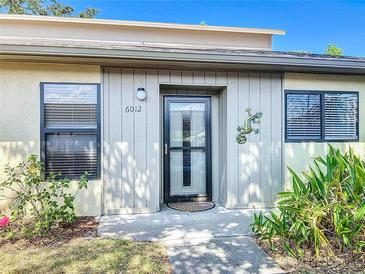 Charming front entrance with decorative lizard and updated windows, providing a welcoming curb appeal at 6012 28Th W St, Bradenton, FL 34207