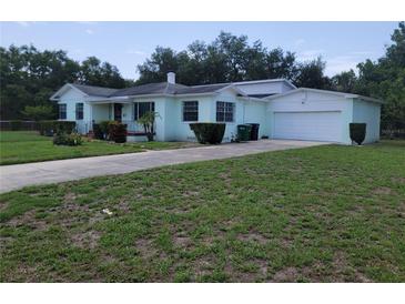 Charming single Gathering home with an attached garage and a well-maintained front yard at 1002 W La Salle St, Tampa, FL 33607