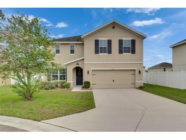 Inviting two-story home featuring a two-car garage and manicured front lawn at 503 Arbequina Ct, Plant City, FL 33566