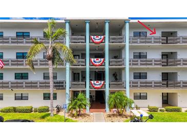 Exterior of building showcasing balconies with patriotic decorations at 5980 80Th N St # 408, St Petersburg, FL 33709