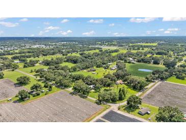 Expansive aerial view of a rural property featuring lush trees and agricultural fields at 1309 Joe Mcintosh Rd, Plant City, FL 33565