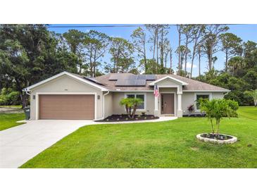 Charming single-story home with a well-maintained lawn and solar panels, enhancing its curb appeal at 4592 Crabapple Ave, North Port, FL 34287