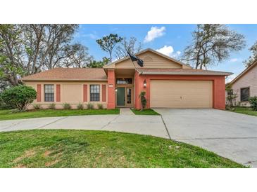 Charming single-Gathering home featuring a well-maintained lawn and attached two car garage at 8050 Eacon Ct, Hudson, FL 34667