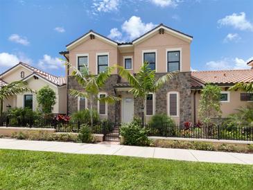Two-story house with stone accents and landscaping at 934 E Venice Ave, Venice, FL 34285