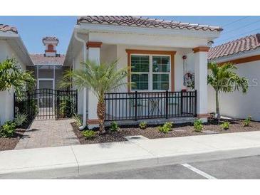 Exterior of charming villa with walkway and landscaped yard at 117 Clifton Way, Venice, FL 34292