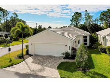 Single-story home with attached garage and well-manicured lawn at 11065 Barnsley Dr, Venice, FL 34293