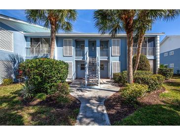 Two-story building with light blue exterior and staircase at 454 Cerromar Rd # 275, Venice, FL 34293