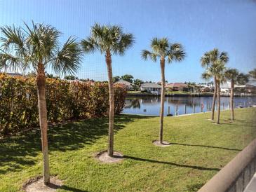 Scenic view of a canal with palm trees and waterfront homes at 601 Shreve St # 51B, Punta Gorda, FL 33950
