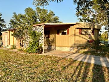 Mobile home with carport and mature landscaping at 5220 Palena Blvd, North Port, FL 34287