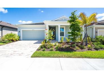 Charming light blue house with a well-manicured lawn at 20450 Bandera Pl, Venice, FL 34293