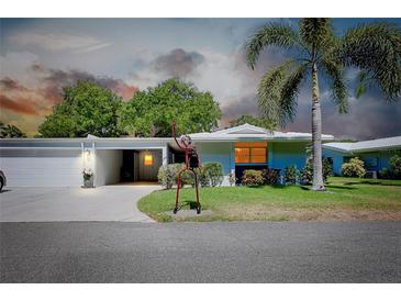 Ranch-style home with attached garage and landscaped lawn at 1350 Stafford Ln # 1422, Sarasota, FL 34232