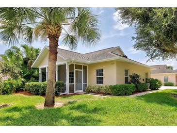 Single-story house with screened porch and palm tree at 1264 Red Oak Ln, Port Charlotte, FL 33948