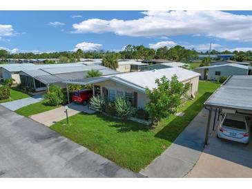 Aerial view of a single-Gathering home in a residential community at 107 Tahitian Way, North Port, FL 34287