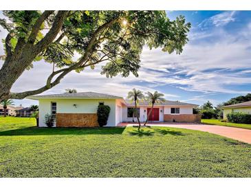 Charming ranch-style home with a spacious lawn and mature tree at 1708 Shoals Ct, Venice, FL 34293