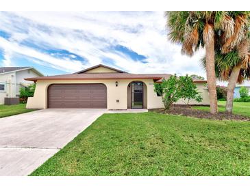 Single-Gathering home with two-car garage and manicured lawn at 1411 Strada D Argento, Venice, FL 34292