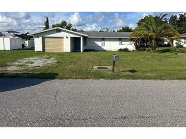 Ranch-style home with carport and mature landscaping at 3485 Roslyn Rd, Venice, FL 34293