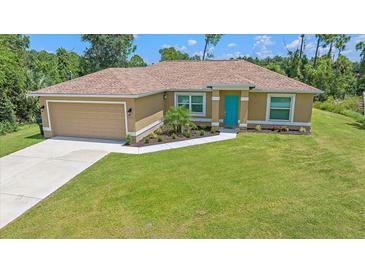 Single-story home with attached garage and landscaped yard at 5742 Janus Ave, North Port, FL 34288