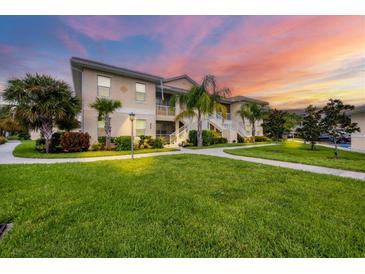 Condo building exterior with landscaping and walkway at 200 Gardens Edge Dr # 213, Venice, FL 34285