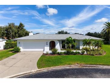 Single story home with attached garage; well maintained landscaping at 1009 Tam O Shanter Ct, Venice, FL 34293