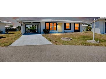 White and gray single-story house with carport and landscaping at 475 Circlewood Dr # O18, Venice, FL 34293