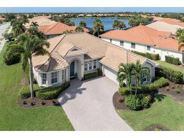 Luxury house with a tile roof and a large driveway at 145 Montelluna Dr, North Venice, FL 34275