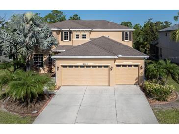 Two-story house with a three-car garage and landscaping at 2585 Hobblebrush Dr, North Port, FL 34289