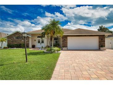 House exterior features stone accents and a brick driveway at 5280 E Sunnydale Cir, Sarasota, FL 34233